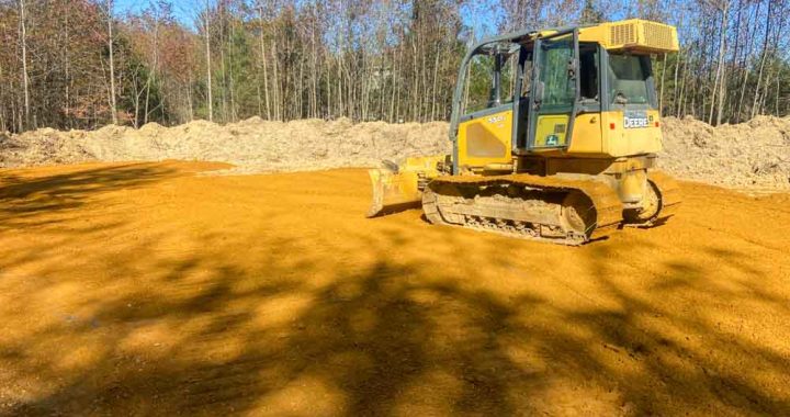 Bulldozer leveling the ground in preparation of the site for construction